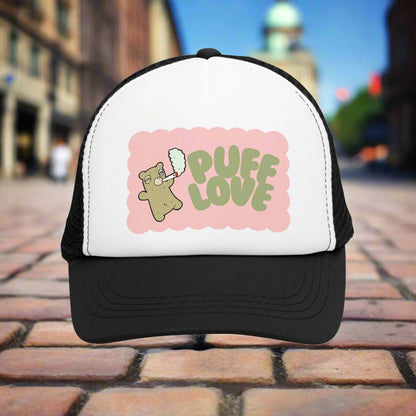 Vintage-style trucker cap with a playful 'Puff Love' design, featuring a cute and funny marijuana-themed graphic. The hat includes a mesh back and adjustable snapback closure, suitable for both men and women. Ideal as a silly 420-themed gift for adults who appreciate stoner humor and retro-inspired accessories.