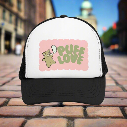 Vintage-style trucker cap with a playful 'Puff Love' design, featuring a cute and funny marijuana-themed graphic. The hat includes a mesh back and adjustable snapback closure, suitable for both men and women. Ideal as a silly 420-themed gift for adults who appreciate stoner humor and retro-inspired accessories.