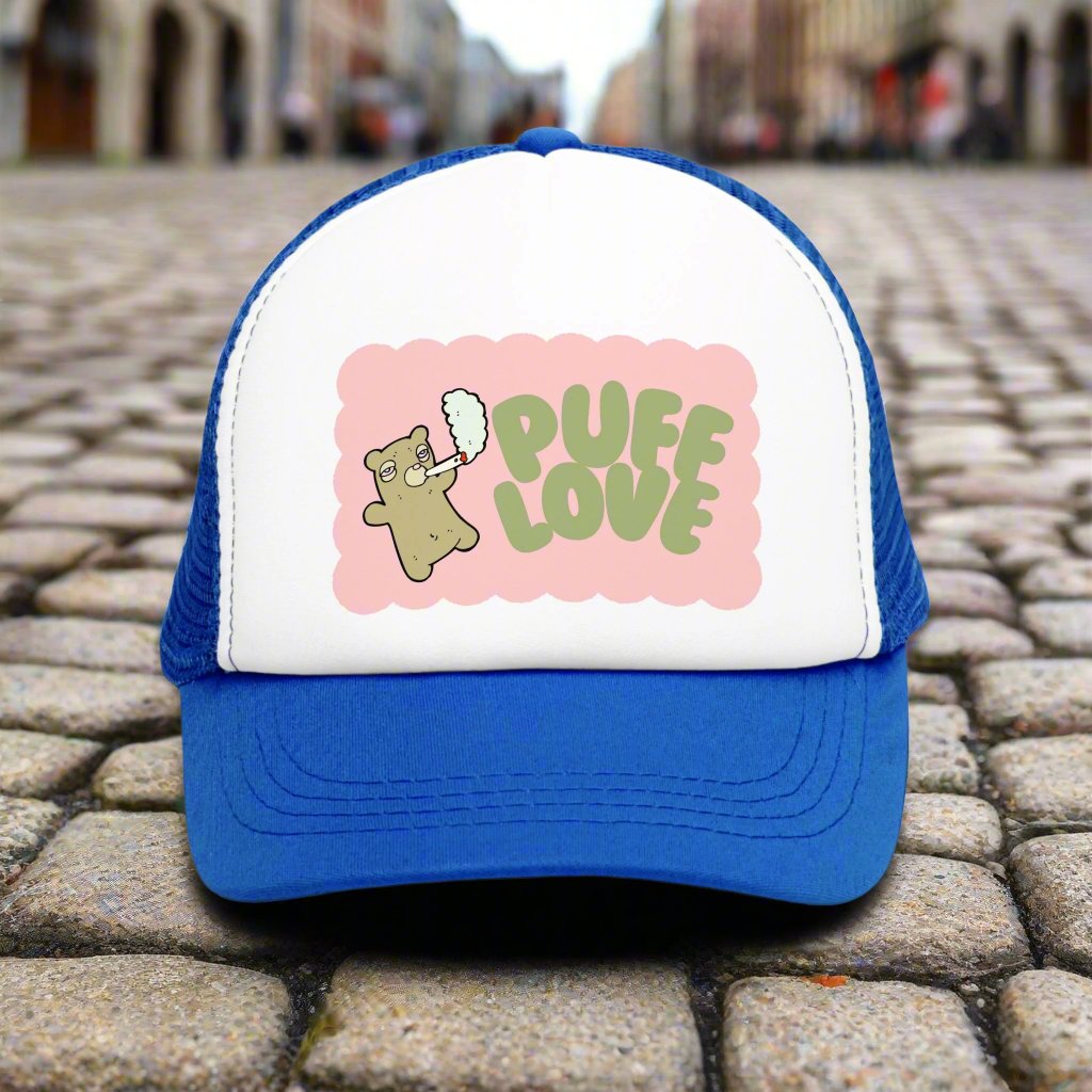 Vintage-style trucker cap with a playful 'Puff Love' design, featuring a cute and funny marijuana-themed graphic. The hat includes a mesh back and adjustable snapback closure, suitable for both men and women. Ideal as a silly 420-themed gift for adults who appreciate stoner humor and retro-inspired accessories.