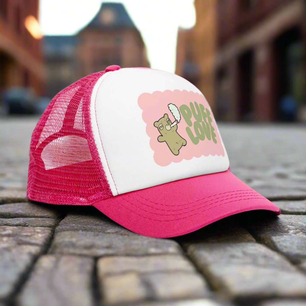 Vintage-style trucker cap with a playful 'Puff Love' design, featuring a cute and funny marijuana-themed graphic. The hat includes a mesh back and adjustable snapback closure, suitable for both men and women. Ideal as a silly 420-themed gift for adults who appreciate stoner humor and retro-inspired accessories.