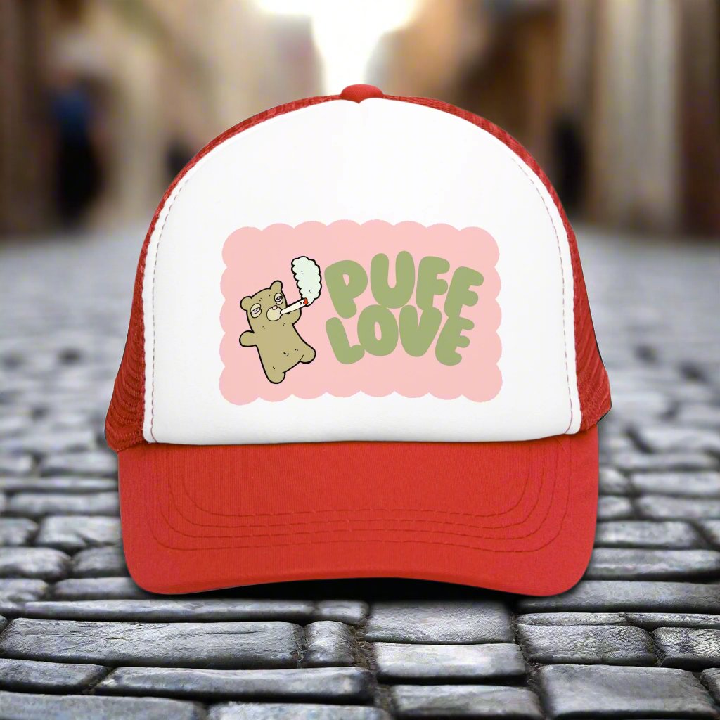 Vintage-style trucker cap with a playful 'Puff Love' design, featuring a cute and funny marijuana-themed graphic. The hat includes a mesh back and adjustable snapback closure, suitable for both men and women. Ideal as a silly 420-themed gift for adults who appreciate stoner humor and retro-inspired accessories.