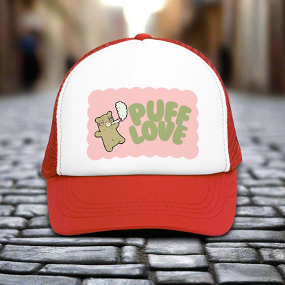 Vintage-style trucker cap with a playful 'Puff Love' design, featuring a cute and funny marijuana-themed graphic. The hat includes a mesh back and adjustable snapback closure, suitable for both men and women. Ideal as a silly 420-themed gift for adults who appreciate stoner humor and retro-inspired accessories.