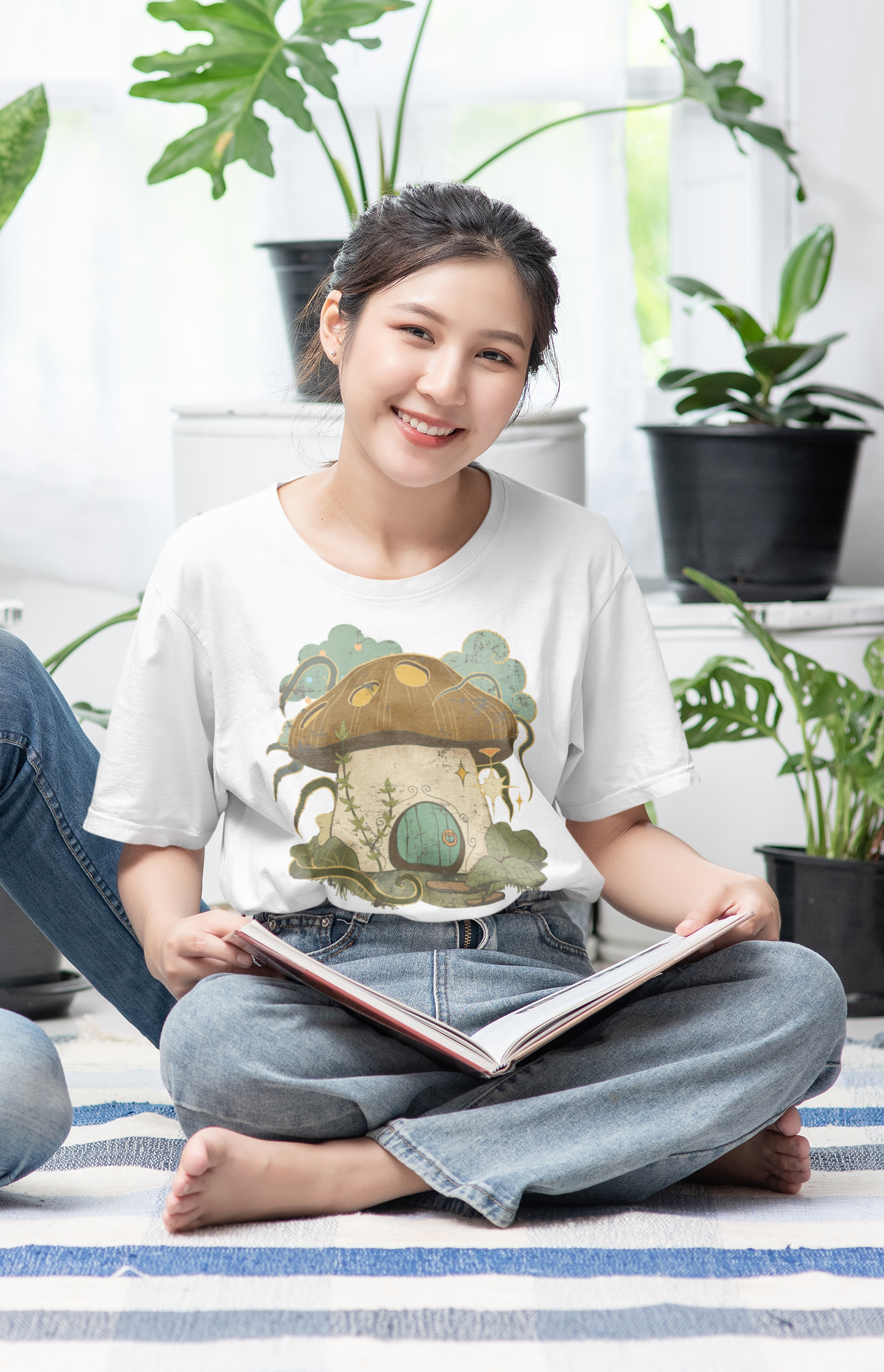Cottagecore-inspired t-shirt featuring a cute mushroom house on the front and whimsical mushrooms on the sleeves, crafted from 100% cotton for comfort and durability